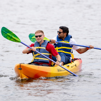 Two men in a kayak on the lake.