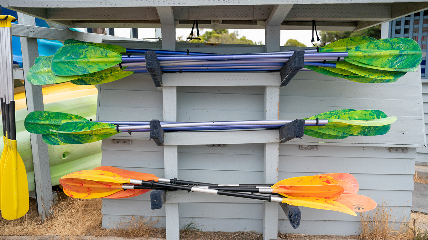 Kayak paddles stacked up.