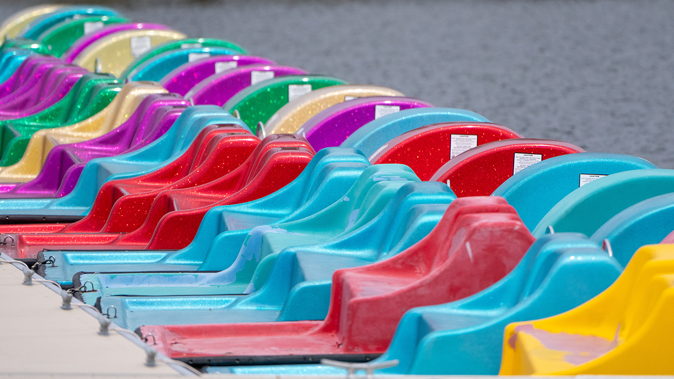 A row of colorful paddleboats lined up on the dock