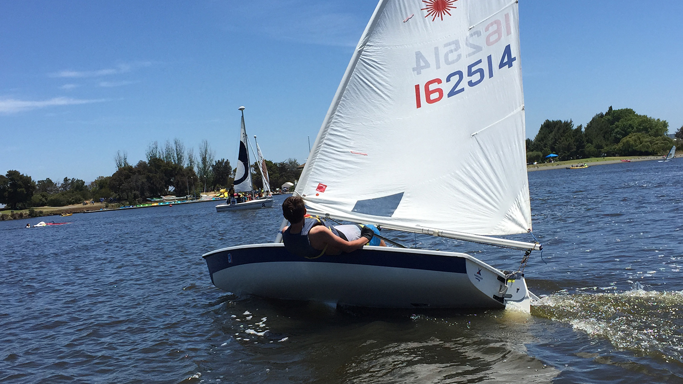 A person doing and advanced move on a performance sailboat