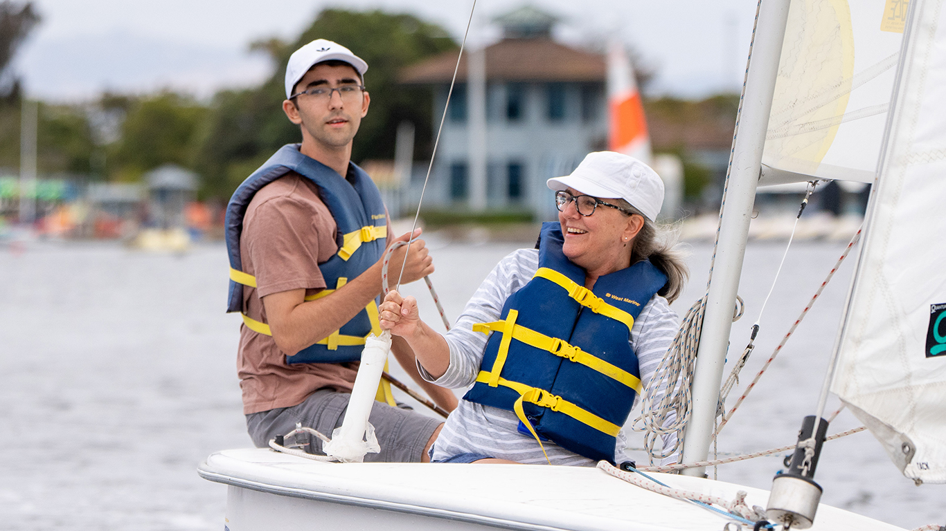 A man and woman having fun while sailing