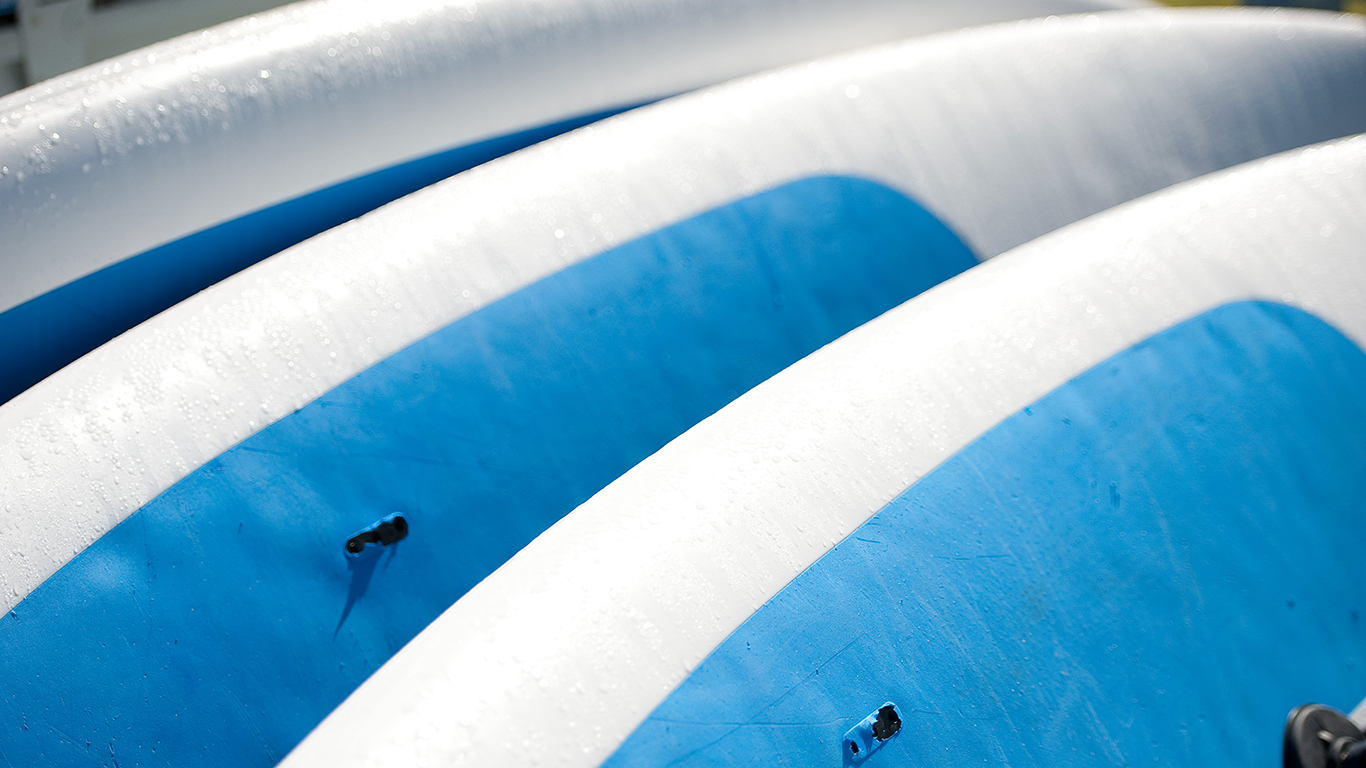 Windsurfing boards all lined up.