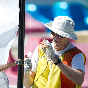 A man preping a boat for sailing