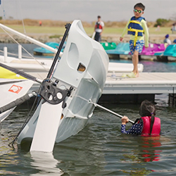 A young girl in with a capsized boat.